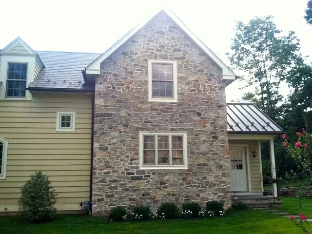 Restored fieldstone gable end of a historic farmhouse