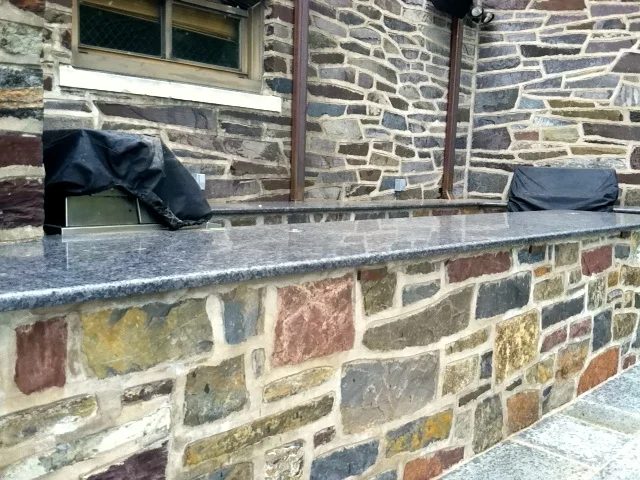 Close-up of a fieldstone wall with a granite cap